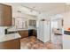 Kitchen with granite countertops, stainless steel sink, brown cabinetry, and tile flooring at 728 Twilight Blue Ave, North Las Vegas, NV 89032
