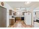 Kitchen featuring granite countertops, stainless steel range, and dark cabinetry with bright refrigerator at 728 Twilight Blue Ave, North Las Vegas, NV 89032