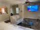 Open-concept living room showing modern interior with a sofa, ceiling fan, and a view of the kitchen at 728 Twilight Blue Ave, North Las Vegas, NV 89032