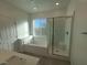 Bright bathroom featuring tub, shower, and modern fixtures, providing a clean and relaxing space at 7332 N Decatur Blvd # 2, North Las Vegas, NV 89084