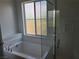 Bright bathroom features a soaking tub beneath a privacy window at 7332 N Decatur Blvd # 2, North Las Vegas, NV 89084