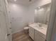 This bathroom has a white vanity with modern fixtures and light wood style floors at 7332 N Decatur Blvd # 2, North Las Vegas, NV 89084