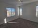 This bedroom has neutral walls and carpet with natural light from three windows at 7332 N Decatur Blvd # 2, North Las Vegas, NV 89084