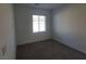 This carpeted bedroom has neutral walls and one window at 7332 N Decatur Blvd # 2, North Las Vegas, NV 89084