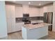 Well-lit kitchen with stainless steel appliances, granite countertops, and ample white cabinetry at 7332 N Decatur Blvd # 2, North Las Vegas, NV 89084