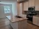 Bright kitchen featuring a large island with granite countertop, stainless steel appliances, and ample storage at 7332 N Decatur Blvd # 2, North Las Vegas, NV 89084
