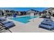 Community pool area featuring lounge chairs and umbrellas for relaxation and enjoyment at 7332 N Decatur Blvd # 2, North Las Vegas, NV 89084