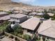 Backyard aerial view showcasing desert landscaped yard with covered patio area in a vibrant community at 759 Star Apple Ln, Las Vegas, NV 89178