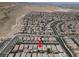 Expansive aerial view of a desert community with many homes, roads and mountains in the background on a sunny day at 759 Star Apple Ln, Las Vegas, NV 89178