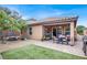 Charming backyard with a covered patio, lush green lawn, and play area for outdoor enjoyment at 759 Star Apple Ln, Las Vegas, NV 89178