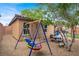 Gathering-friendly backyard with play area, picnic table, and manicured landscaping for outdoor enjoyment at 759 Star Apple Ln, Las Vegas, NV 89178