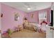 Pink ' bedroom featuring bed, play area, and natural light from the window at 759 Star Apple Ln, Las Vegas, NV 89178