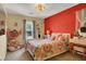 Colorful bedroom with window seat and large floral comforter at 759 Star Apple Ln, Las Vegas, NV 89178