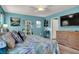 Bright primary bedroom with coastal decor, light blue walls, and a ceiling fan at 759 Star Apple Ln, Las Vegas, NV 89178
