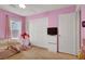 Cozy pink bedroom with window, closet, and charming play area at 759 Star Apple Ln, Las Vegas, NV 89178