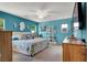 Bright and airy bedroom with calming turquoise walls, plush bedding, and ample natural light at 759 Star Apple Ln, Las Vegas, NV 89178
