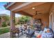 Inviting covered patio with comfortable seating, perfect for relaxing and enjoying the landscaped backyard at 759 Star Apple Ln, Las Vegas, NV 89178