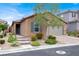Charming single-story home featuring a well-manicured front yard, stone accents, and a welcoming entrance at 759 Star Apple Ln, Las Vegas, NV 89178