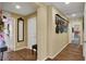 Hallway with wood floors and decorative picture frames on the wall at 759 Star Apple Ln, Las Vegas, NV 89178