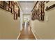 Hallway adorned with Gathering photos and warm lighting, leading towards the main living areas at 759 Star Apple Ln, Las Vegas, NV 89178