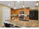 Modern kitchen with granite countertops, stainless steel appliances, and an island with breakfast bar seating at 759 Star Apple Ln, Las Vegas, NV 89178