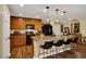 Open kitchen with bar seating, warm-toned cabinets, granite counters, and modern appliances with plenty of counter space at 759 Star Apple Ln, Las Vegas, NV 89178