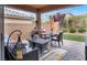 Inviting covered patio with a dining table and colorful decor, perfect for outdoor living at 759 Star Apple Ln, Las Vegas, NV 89178