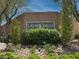 Laurel Hills community entrance with brick sign, lush foliage and stone accents under a blue sky at 759 Star Apple Ln, Las Vegas, NV 89178