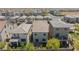 An aerial view shows the backyard of houses in a suburban neighborhood with desert landscaping under a blue sky at 7977 Texas Hills St, Las Vegas, NV 89113