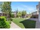 A well-maintained backyard with artificial turf and a patio area offers a perfect blend of relaxation and low-maintenance appeal at 7977 Texas Hills St, Las Vegas, NV 89113