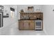 Stylish bar area with sleek countertops, brick backsplash, and beverage cooler at 7977 Texas Hills St, Las Vegas, NV 89113