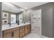This primary bathroom includes a double sink vanity, modern fixtures, and a walk-in closet at 7977 Texas Hills St, Las Vegas, NV 89113