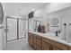 Modern bathroom featuring a glass-enclosed shower and double vanity with contemporary fixtures at 7977 Texas Hills St, Las Vegas, NV 89113