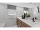 Bathroom with double sinks, modern fixtures, and a shower-tub combination at 7977 Texas Hills St, Las Vegas, NV 89113