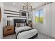 Bedroom with modern decor, accent wall, ample natural light, and stylish furniture at 7977 Texas Hills St, Las Vegas, NV 89113