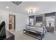 A bedroom featuring a modern chandelier, neutral color palette, and sleek furniture at 7977 Texas Hills St, Las Vegas, NV 89113