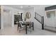Modern dining area features an elegant table, staircase, and an open-concept design at 7977 Texas Hills St, Las Vegas, NV 89113