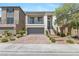 A delightful two-story home showcases a balcony, verdant landscaping, a paved driveway, and an attached two-car garage at 7977 Texas Hills St, Las Vegas, NV 89113