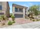Charming two-story home featuring a balcony, well-manicured landscaping, a paved driveway, and an attached two-car garage at 7977 Texas Hills St, Las Vegas, NV 89113