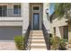 Inviting home entrance with steps leading to the front door, featuring a well-maintained front yard and attached garage at 7977 Texas Hills St, Las Vegas, NV 89113