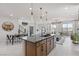 Modern kitchen featuring a large center island with seating, stainless steel appliances, and an open layout to the living spaces at 7977 Texas Hills St, Las Vegas, NV 89113