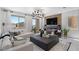 Comfortable living room boasting a modern fireplace, large TV, and a spacious seating area with stylish decor at 7977 Texas Hills St, Las Vegas, NV 89113