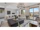 Cozy living area with a plush sofa, stylish rug, plants, and natural light streaming through the large glass doors at 7977 Texas Hills St, Las Vegas, NV 89113