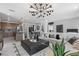 Bright living room featuring modern lighting, stylish decor, and an open floor plan to the kitchen and dining area at 7977 Texas Hills St, Las Vegas, NV 89113