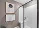 A well-lit glass shower with a bench is accented by modern decor, offering a spa-like experience at 7977 Texas Hills St, Las Vegas, NV 89113