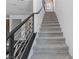 View of the modern carpeted staircase featuring a sleek metal railing that accents the home's style at 7977 Texas Hills St, Las Vegas, NV 89113