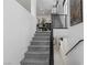 Modern staircase leading to open floor plan with dining area and white walls at 7977 Texas Hills St, Las Vegas, NV 89113