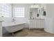 Elegant bathroom featuring a standalone tub, paneled walls, and modern fixtures at 8121 Eagle Clan Ct, Las Vegas, NV 89131