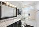 Modern bathroom features a shower over tub and a granite-topped vanity at 8121 Eagle Clan Ct, Las Vegas, NV 89131