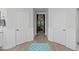 Hallway between bathrooms features wood-style floors and accent wainscoting at 8121 Eagle Clan Ct, Las Vegas, NV 89131
